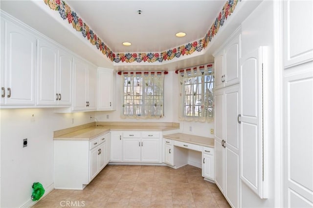 clothes washing area featuring cabinets, light tile patterned flooring, and electric dryer hookup