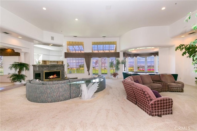 carpeted living room with a premium fireplace