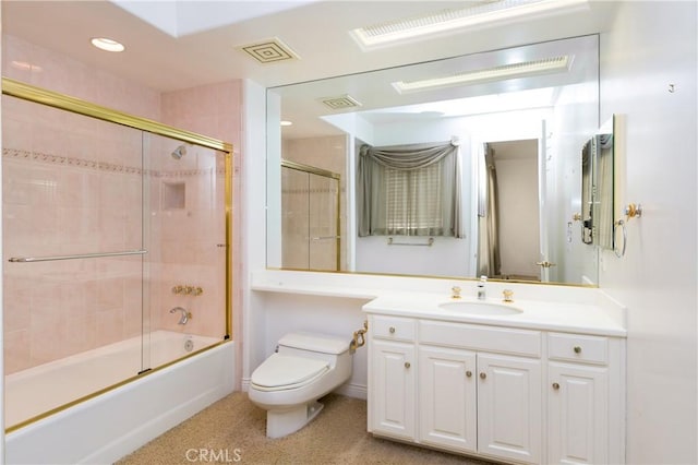 full bathroom featuring toilet, bath / shower combo with glass door, and vanity