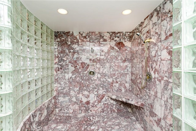 interior details featuring tiled shower