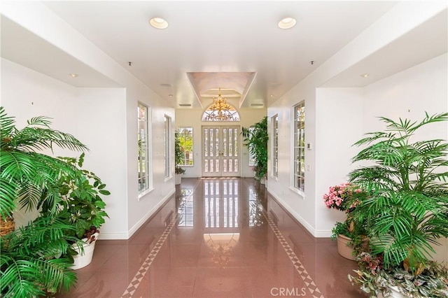 hall with dark tile patterned floors