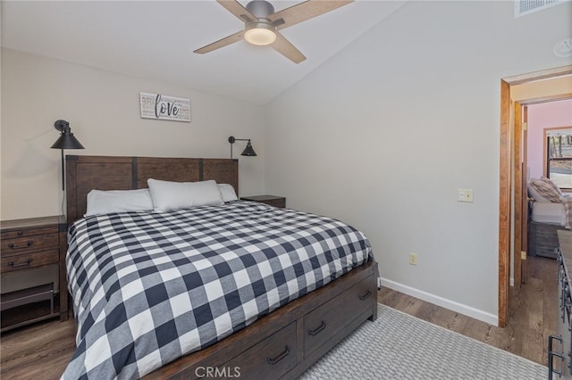 bedroom featuring ceiling fan, lofted ceiling, and light hardwood / wood-style flooring