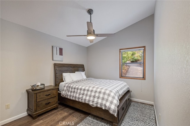 bedroom with hardwood / wood-style flooring, vaulted ceiling, and ceiling fan