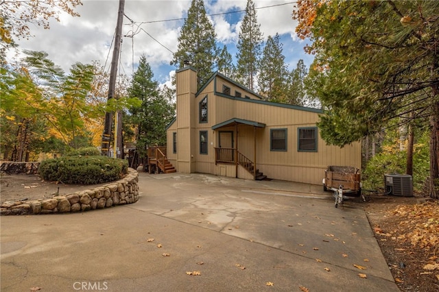 rear view of property with central AC unit