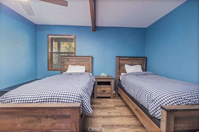 bedroom featuring beamed ceiling, ceiling fan, and light hardwood / wood-style flooring