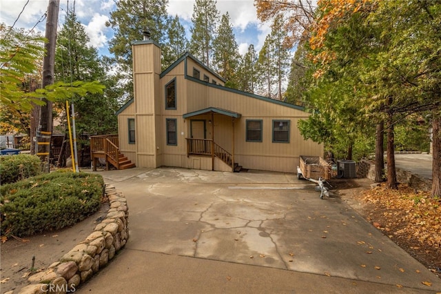 rear view of property with central AC