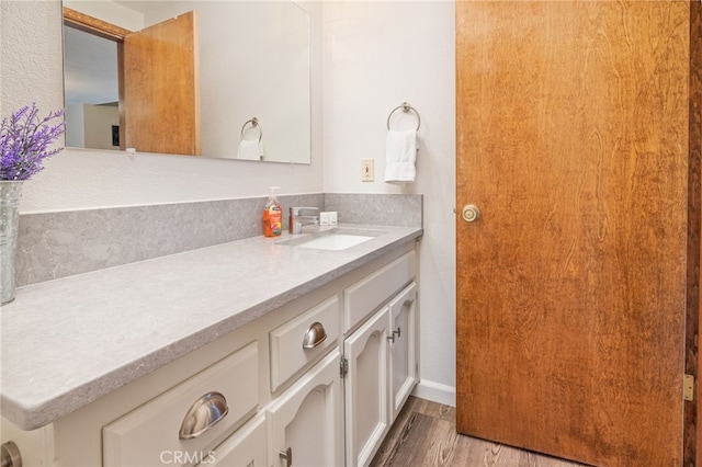 bathroom featuring vanity and hardwood / wood-style flooring