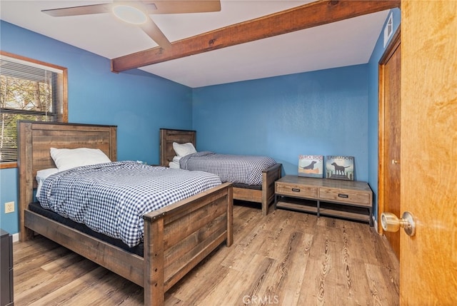 bedroom featuring beam ceiling, ceiling fan, and light hardwood / wood-style floors