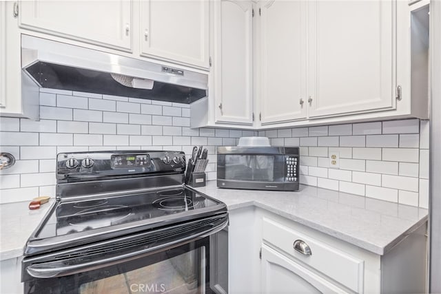 kitchen with white cabinetry, backsplash, and black appliances