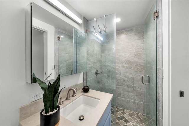 bathroom featuring vanity and an enclosed shower