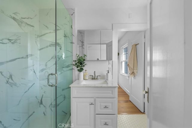 bathroom featuring vanity and a shower with shower door