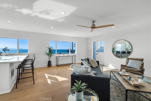 1000 The Strand, Manhattan Beach, CA 90266 - living room with light wood-type flooring, recessed lighting, ceiling fan, a water view, and baseboards