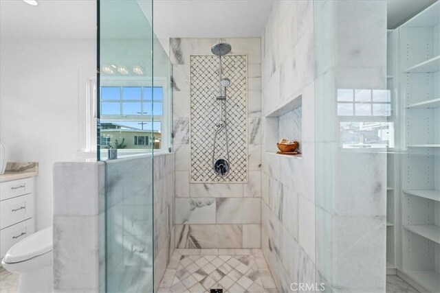 bathroom featuring toilet and an enclosed shower