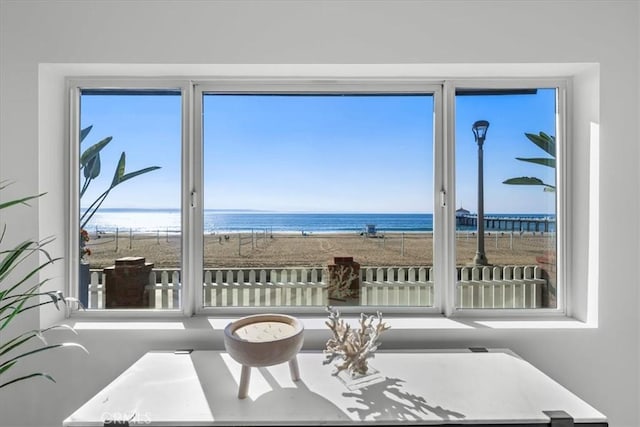 interior space with a water view and a beach view