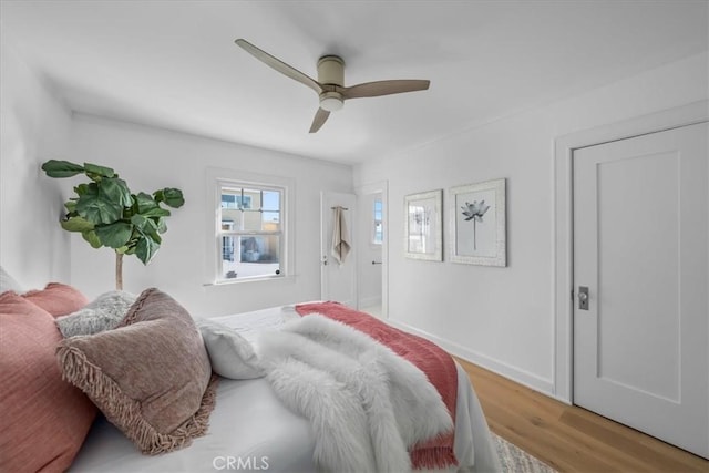 bedroom with hardwood / wood-style floors and ceiling fan