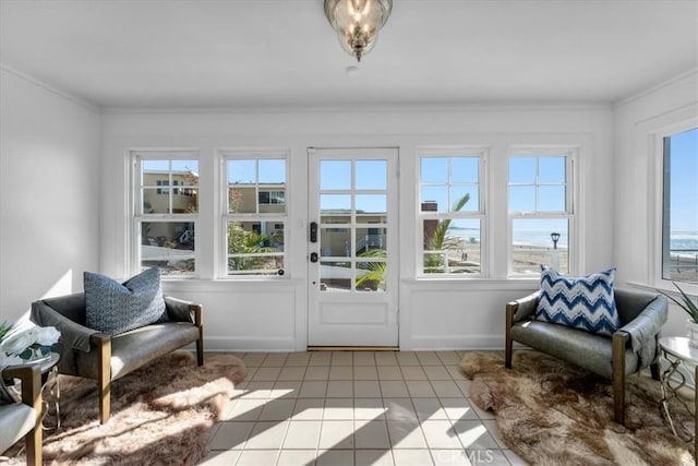 sunroom / solarium with a water view and a wealth of natural light