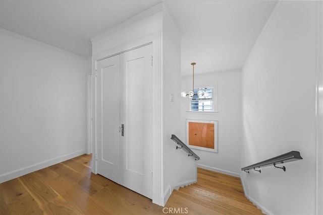 stairs with a chandelier and wood-type flooring