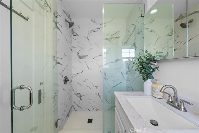 bathroom with vanity and an enclosed shower