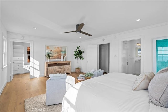 bedroom with light hardwood / wood-style floors, ceiling fan, and crown molding