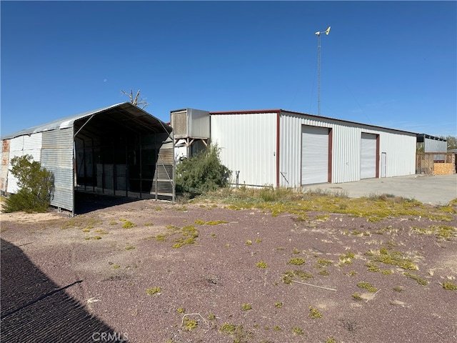 view of outdoor structure with a garage and a carport