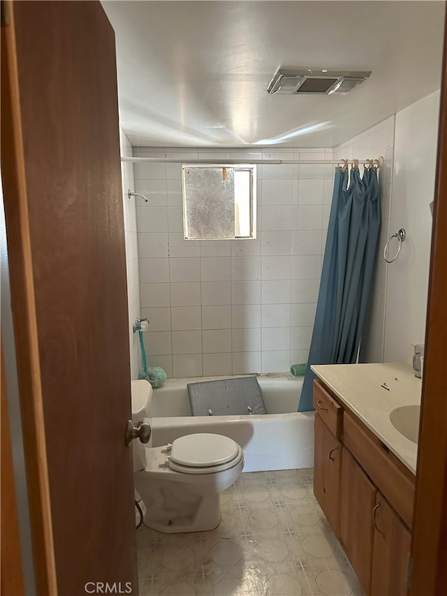 full bathroom with toilet, vanity, and shower / tub combo