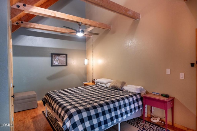 bedroom featuring beamed ceiling, wood-type flooring, and ceiling fan