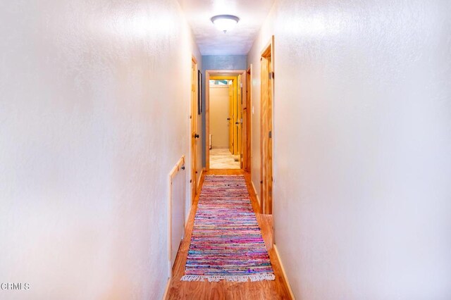 hall with light wood-type flooring