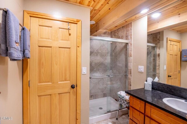 bathroom with vanity, wooden ceiling, and walk in shower