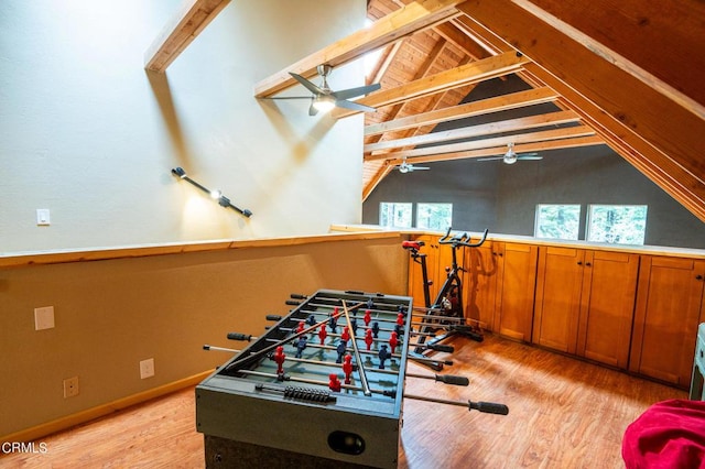 playroom with vaulted ceiling with beams, a healthy amount of sunlight, and light hardwood / wood-style floors