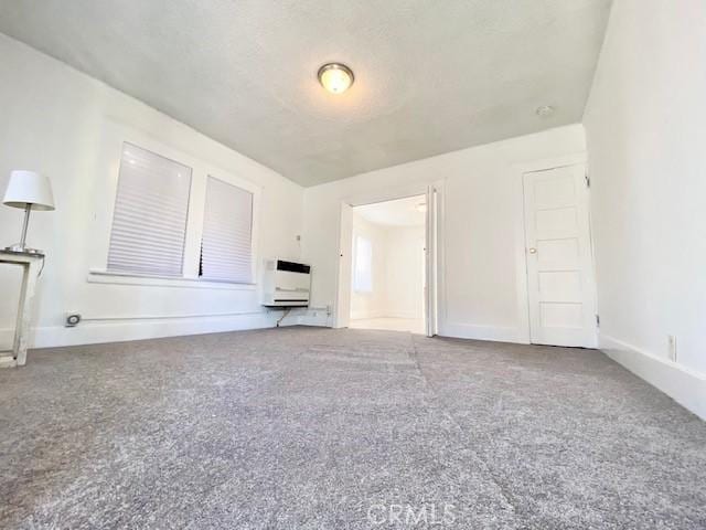 unfurnished living room featuring carpet flooring and heating unit