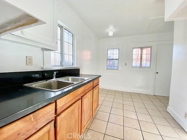 kitchen featuring a wealth of natural light, sink, and light tile patterned floors