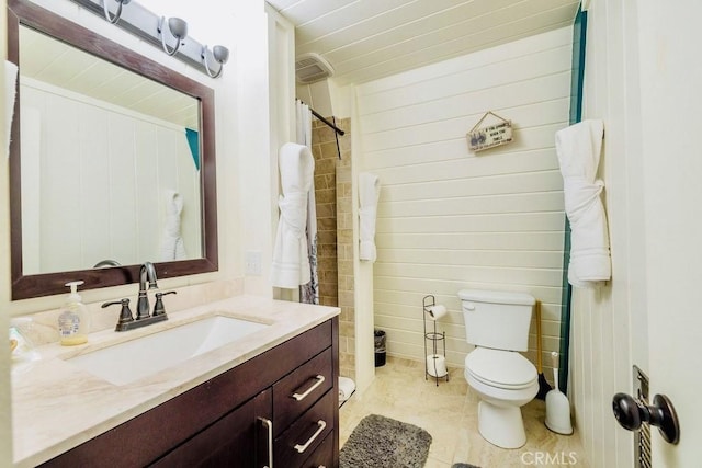 bathroom with vanity, a shower with shower curtain, toilet, and wood walls