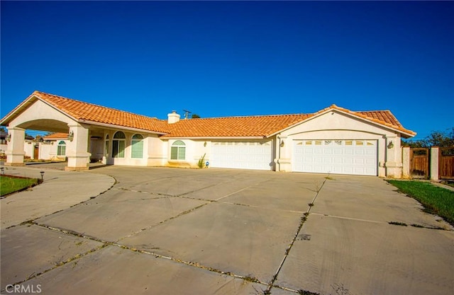 mediterranean / spanish house with a garage