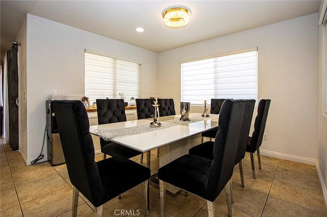 dining area featuring light tile patterned flooring