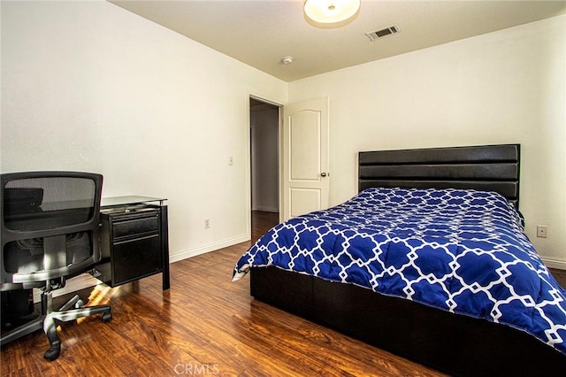 bedroom with dark wood-type flooring