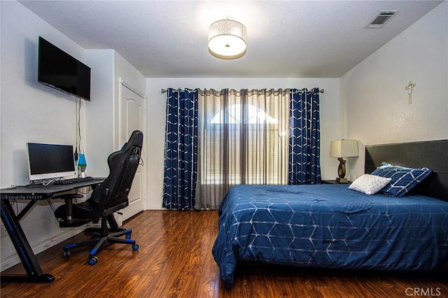 bedroom featuring dark wood-type flooring