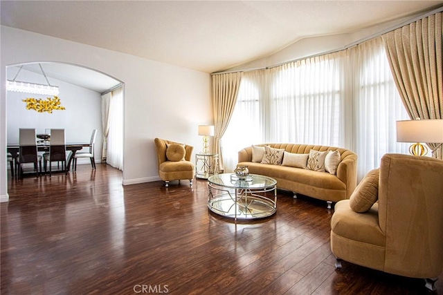 living room with vaulted ceiling and dark hardwood / wood-style floors