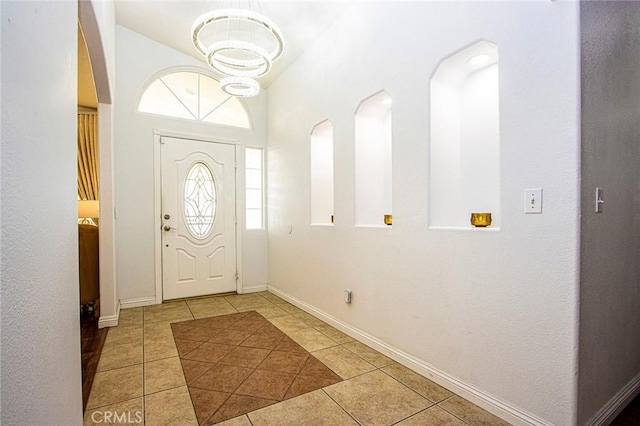 tiled foyer entrance featuring vaulted ceiling