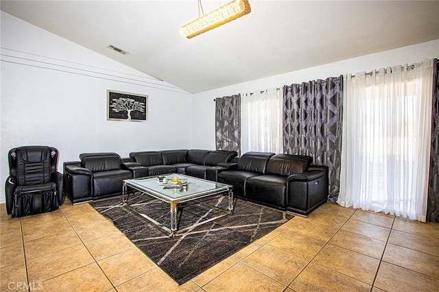 tiled living room featuring vaulted ceiling