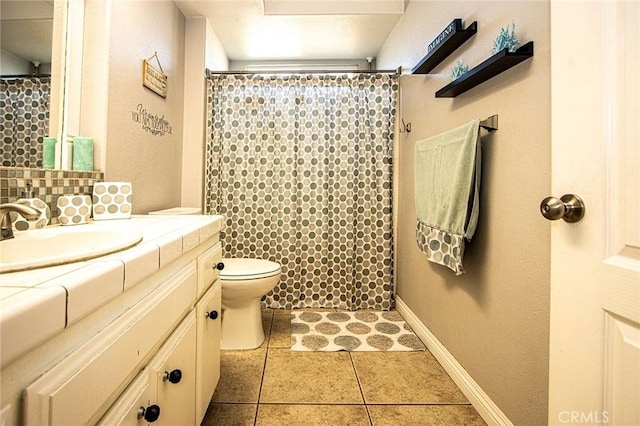 bathroom featuring toilet, vanity, tile patterned floors, and a shower with shower curtain