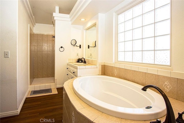 bathroom with vanity, wood-type flooring, and plus walk in shower