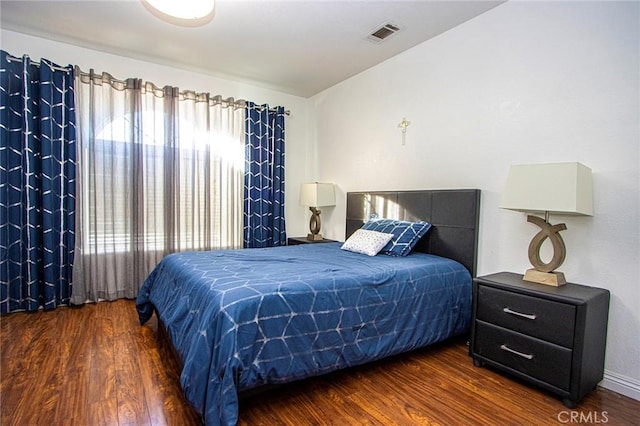 bedroom featuring dark hardwood / wood-style flooring