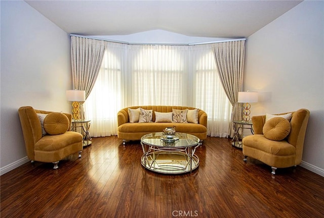 living room with dark hardwood / wood-style floors and vaulted ceiling