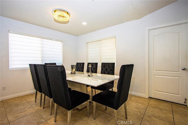 dining room featuring light tile patterned floors and vaulted ceiling