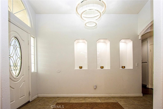 entryway featuring light tile patterned floors and an inviting chandelier