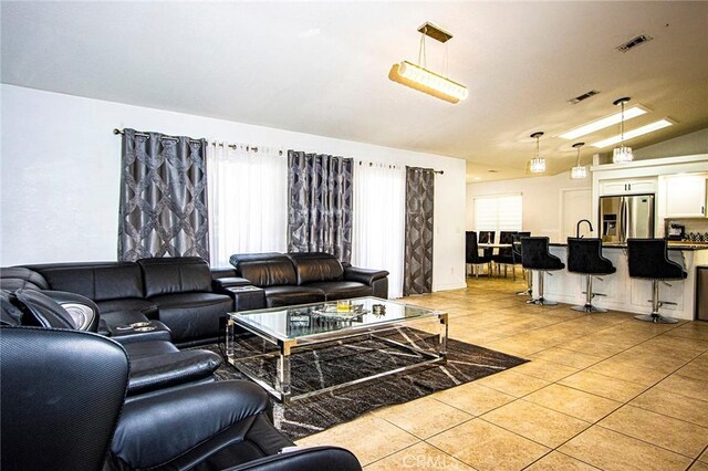 living room featuring light tile patterned flooring and lofted ceiling