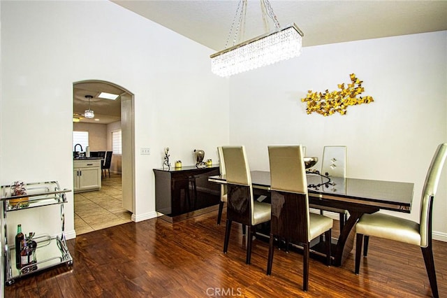 dining area featuring wood-type flooring and an inviting chandelier