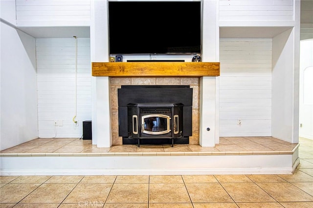 interior details with a wood stove and wood walls