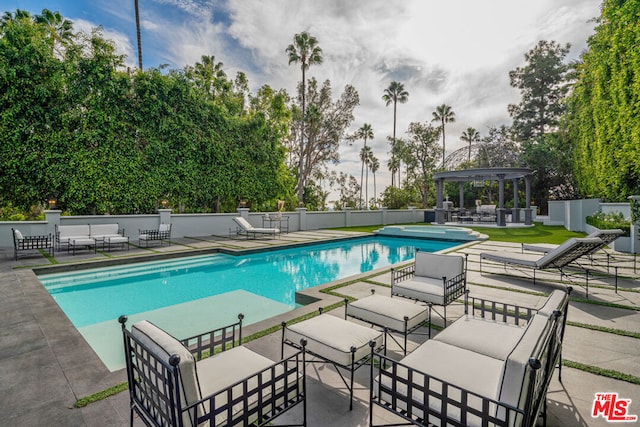 view of swimming pool with a gazebo and a patio area