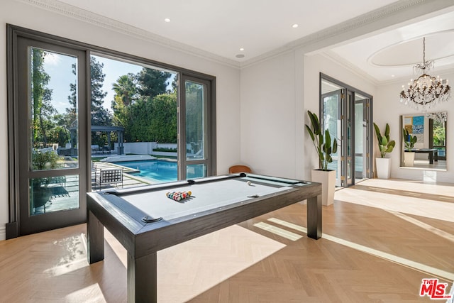 rec room featuring ornamental molding, a chandelier, light parquet floors, and billiards